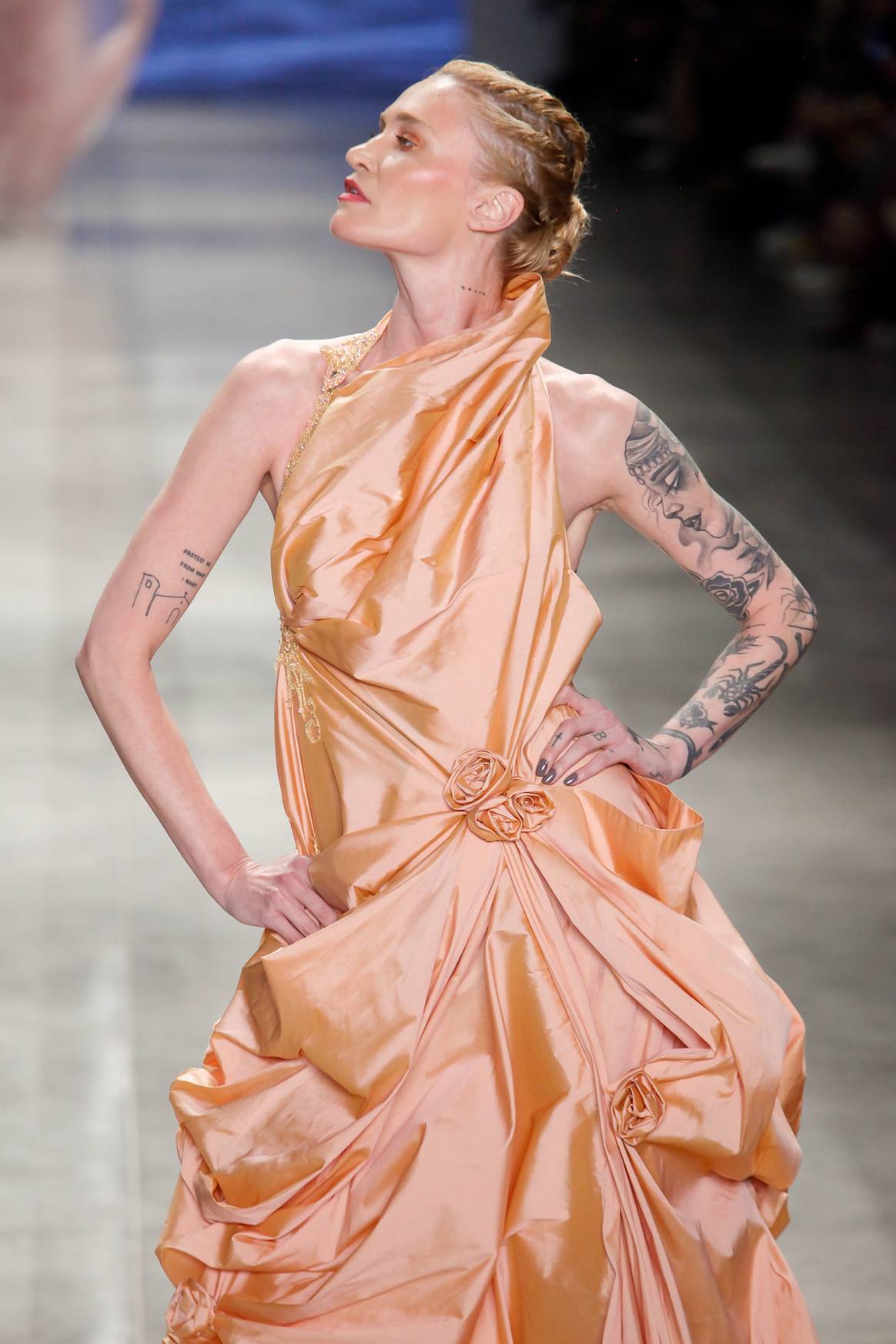 Fruncidos de satén sujetos con rosas del mismo tejido aportan volumen al vestido de Lino Villaventura