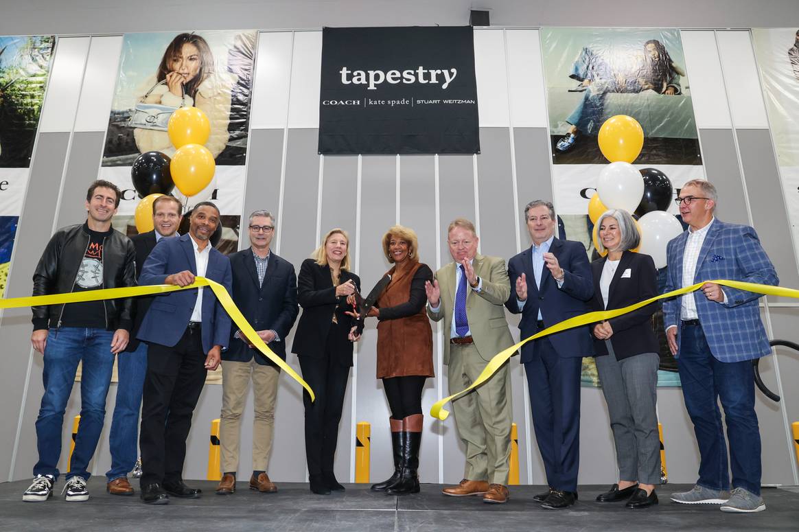 Coach CEO Todd Kahn, third from the right, with Tapestry execs at the ribbon cutting ceremony for the opening of the North Las Vegas FulFilment Centre.