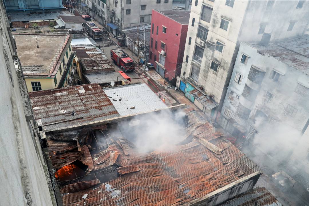 Firefighters douse flames as smoke rises from  burning chemical and garments factory in Dhaka (October 14, 2025)