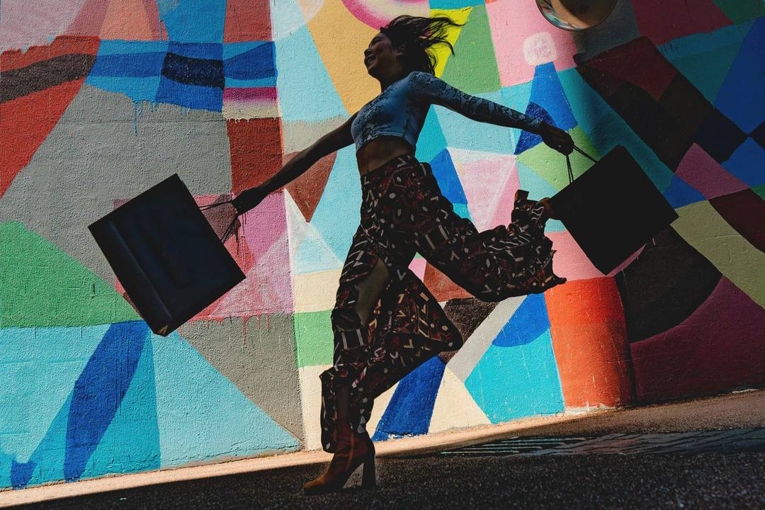 Young woman with shopping bags. Image for illustrative purposes.