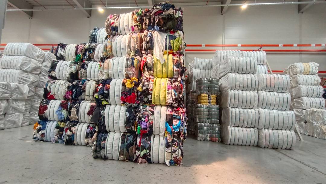 An impressive stack of clothes, pre-sorted and ready for their new life.