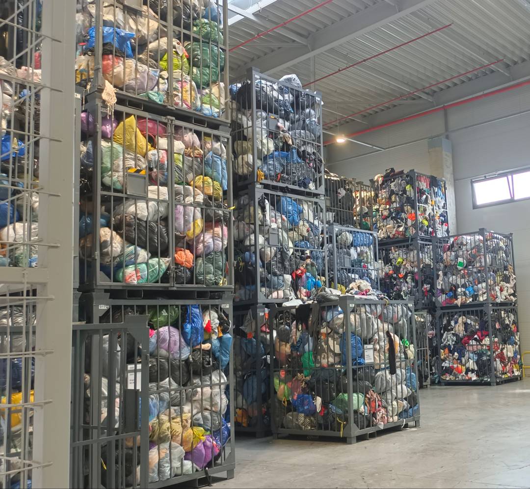 Up to the ceiling - post-consumer garments that have come in through TexCycle containers and other routes.