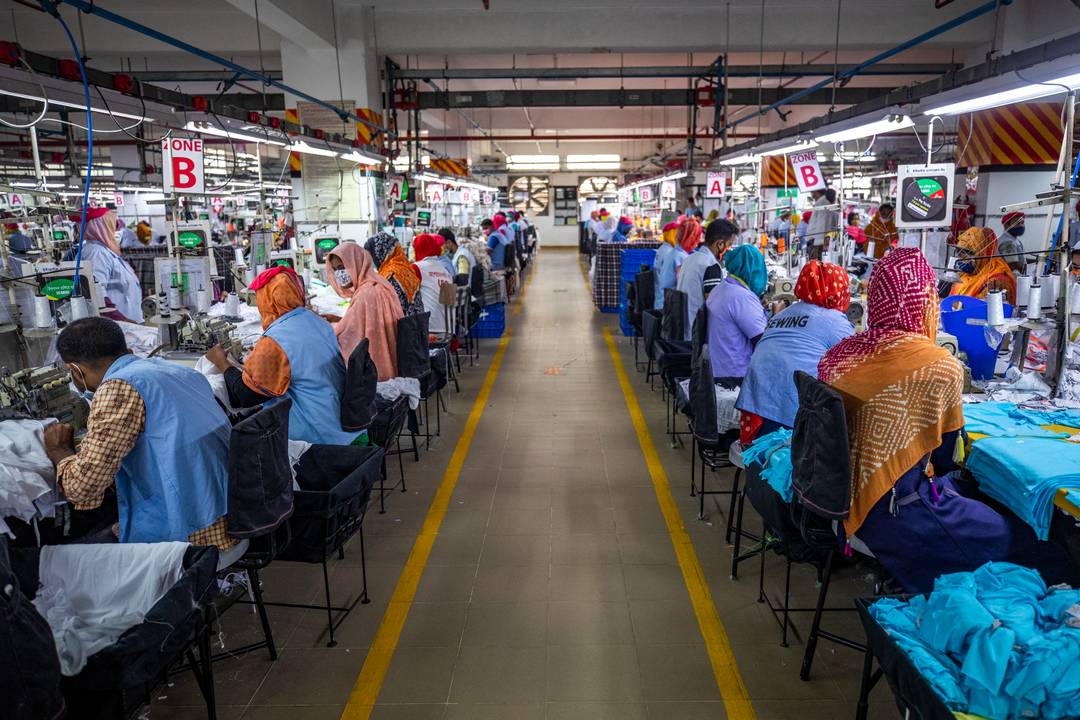 Illustrating image of apparel production and textile workers. Description: Ready made garments worker works in a garments factory in Gazipur on March 22, 2021