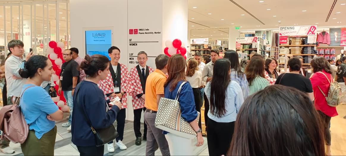 Uniqlo India CFO Kenji Inoue (left) and CEO Tomohiko Sei greeting customers as they enter the first Mumbai store. Credits: FashionUnited