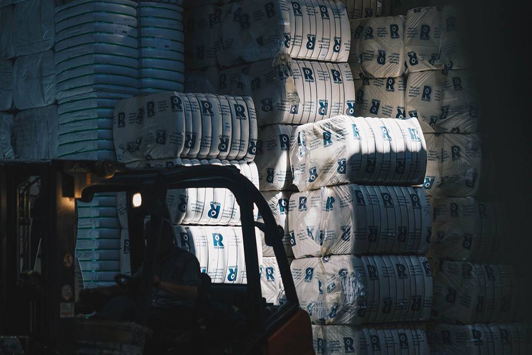 Interior de una zona de almacenaje de Recover con fardos de residuos textiles.