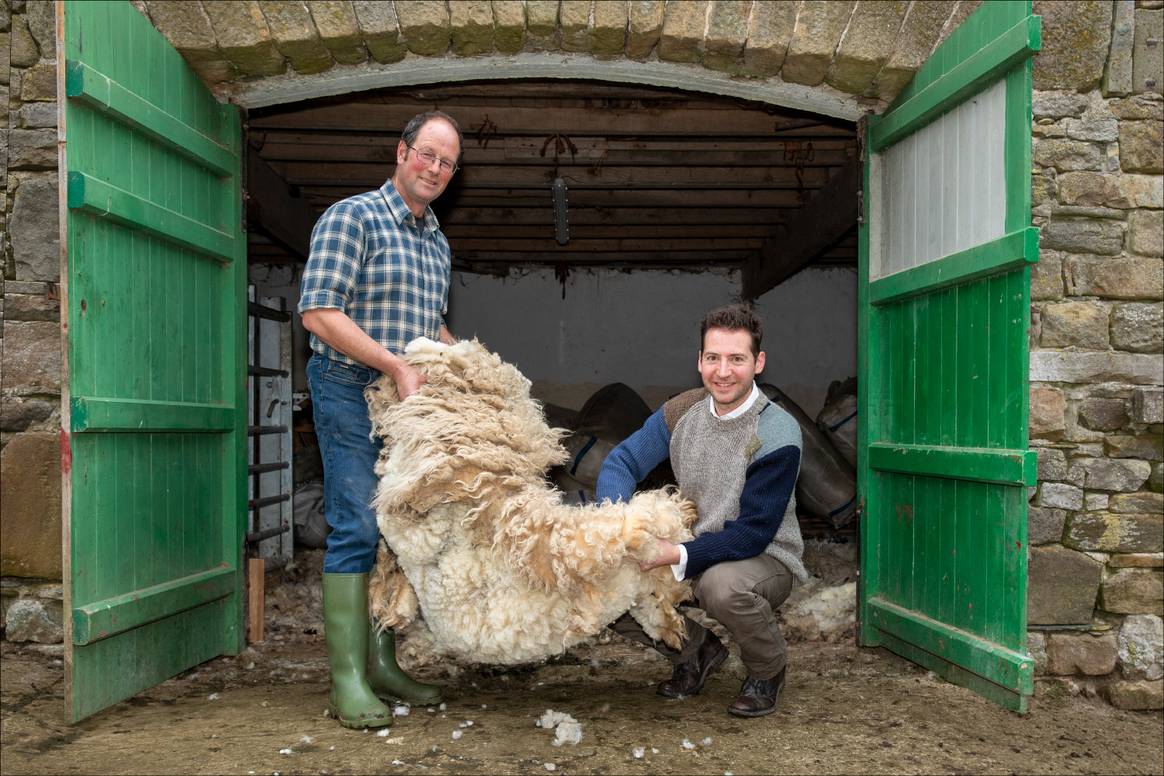 Edward Sexton (right) with local farmer John Dawson holding a full Dalesbred fleece.
