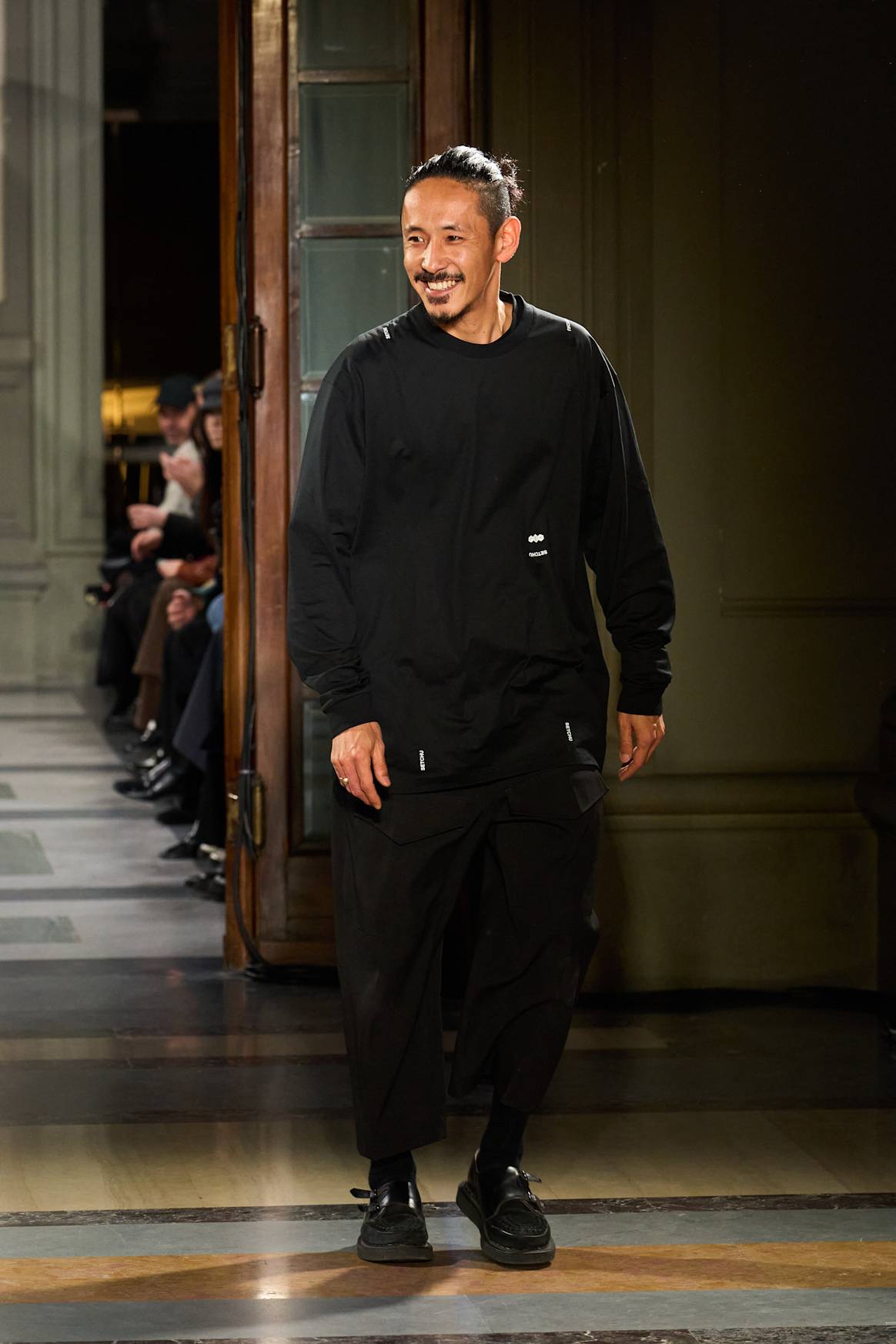 Designer Satoshi Kuwata at the finale of Setchu's FW25 Pitti show.