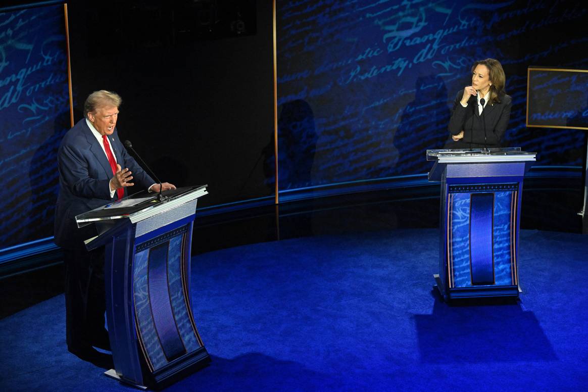 US VP and Democratic presidential candidate Kamala Harris listens as former US president and Republican presidential candidate Donald Trump speaks during a debate at the National Constitution Center in Philadelphia, Pennsylvania, on September 10, 2024.