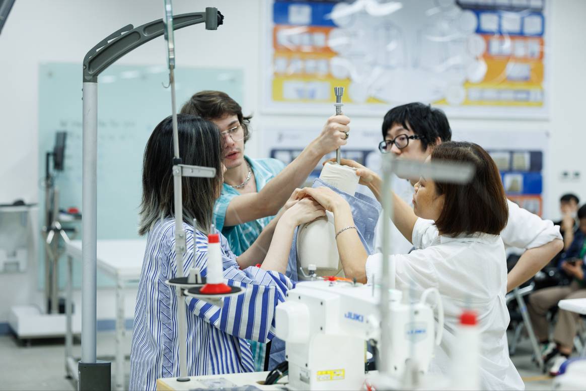 Redress x TAL Ecodesign Challenge participants work on a garment.
