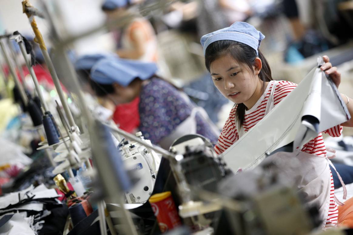 Image: A female worker works at a textile clothing factory in Huaibei, Anhui province, eastern China, on Sept. 1, 2015.  Credit: Photo by Zhengyi Xie / NurPhoto / NurPhoto via AFP