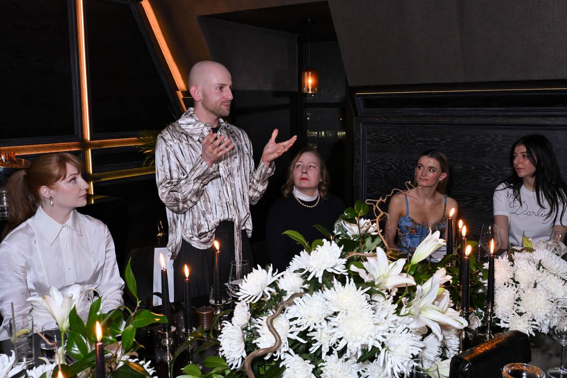 Patrick McDowell (standing) at his intimate LFW dinner in partnership with HUUE and Ecovative.