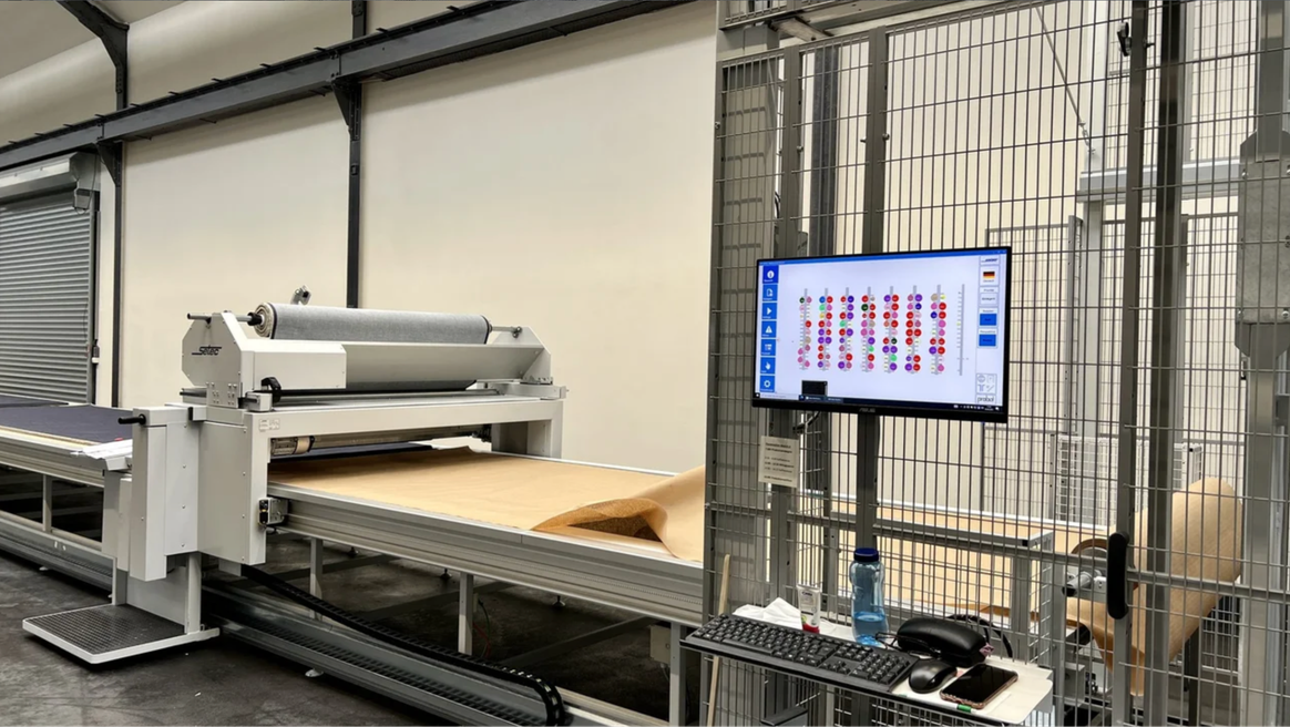 A sample of each fabric will be taken and washed, the shrinkage values and how the colors turned out will be measured and noted. These values are recorded with the roll of fabric in the fully automated "Robby" storage system. The warehouse robot automatically transfers the rolls required to the lay-up table.Credits: C&A FIT ©2022 C. Niehlinger