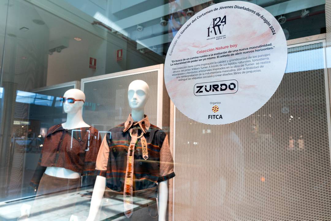 Window display showing Álvaro Castillo's winning collection at Puerto Venecia shopping centre in Zaragoza, Spain