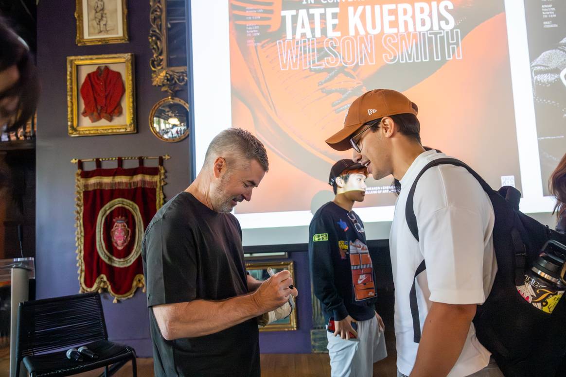 Tate Kuerbis signing a student's Air Jordans at SCAD Sneaker Culture Week 2025