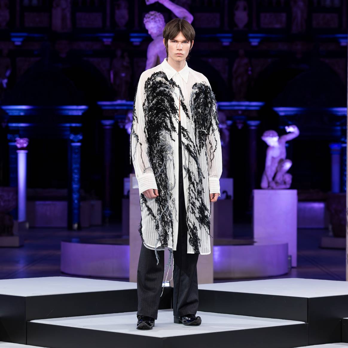 AI-generated fashion from Derek Chan, Wilson Choi, Tak Lee, Sophia XinLi and Aries Sin showed at the V&A Museum in July 2024. This specific look is a design from Aries Sin.