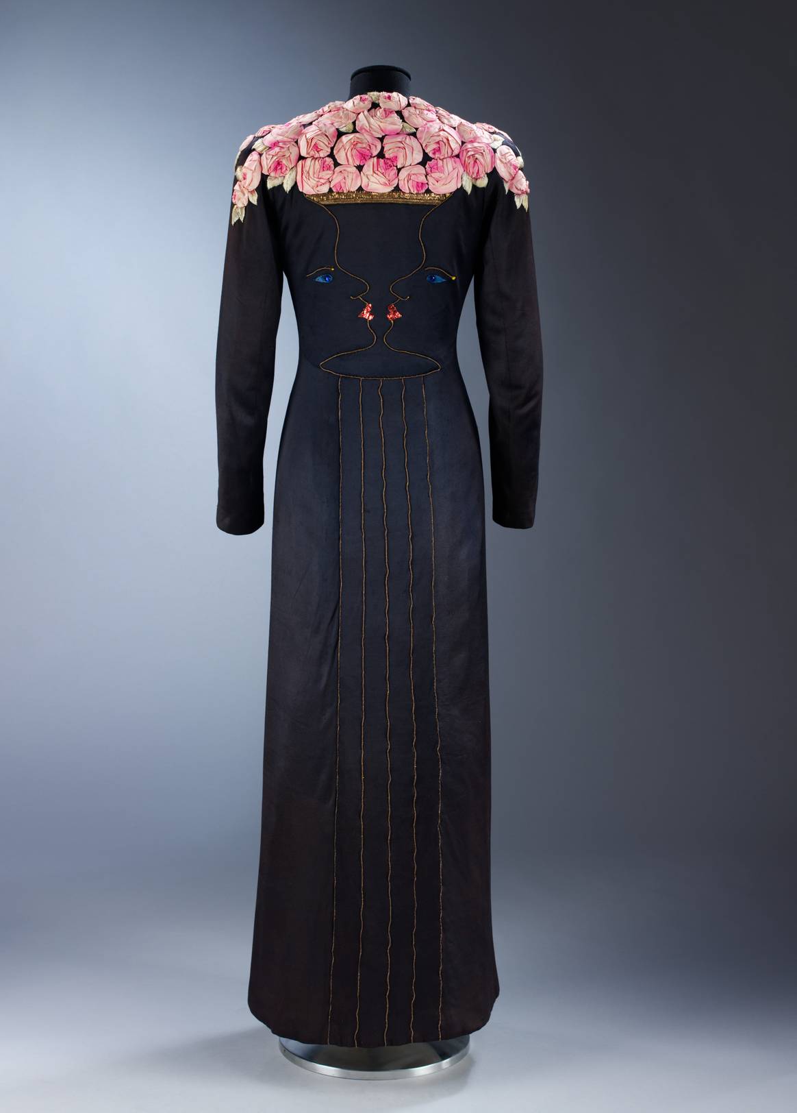 Ankle-length coat of black silk jersey with facial profiles forming a rose-filled vase, Elsa Schiaparelli, Jean Cocteau and Lesage, London, 1937
